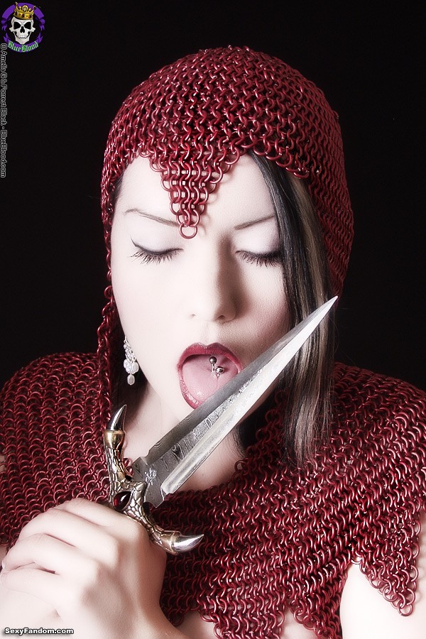 Dahlia Dark in a red chainmail coif