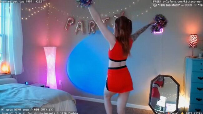 Spirited Cheerleader KittyCorner Plays With Her Pom Poms