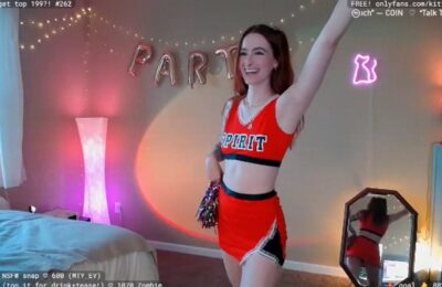 Spirited Cheerleader KittyCorner Plays With Her Pom Poms